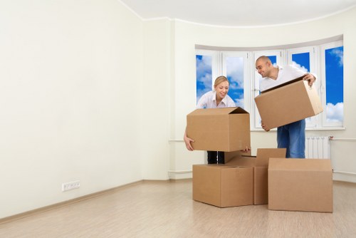 Movers navigating stairs and access in a Wembley Park property