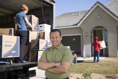 Professional man with van service managing furniture and boxes safely